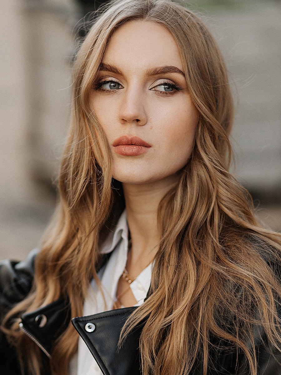 Close-up portrait of a woman with wavy hair.