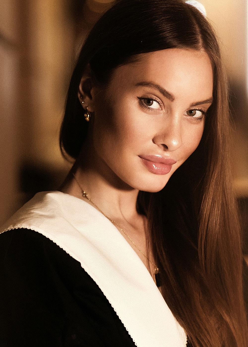 Woman with long hair and elegant attire.