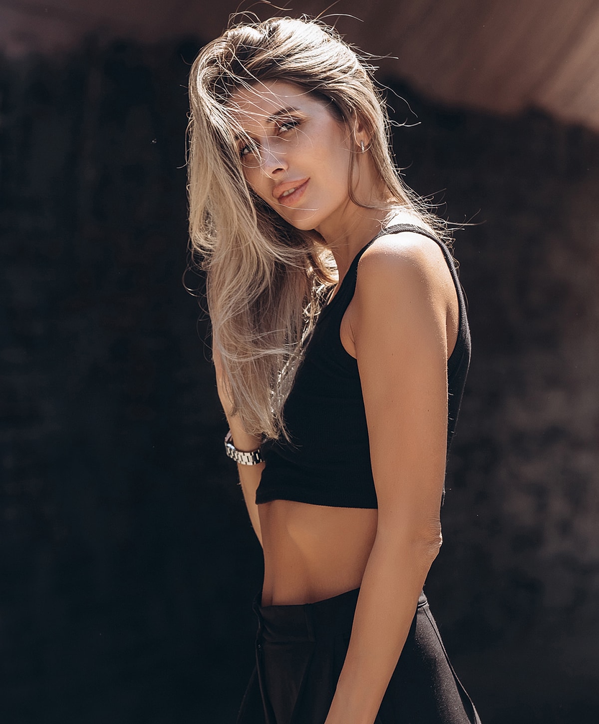 Woman in black outfit with stylish hair.