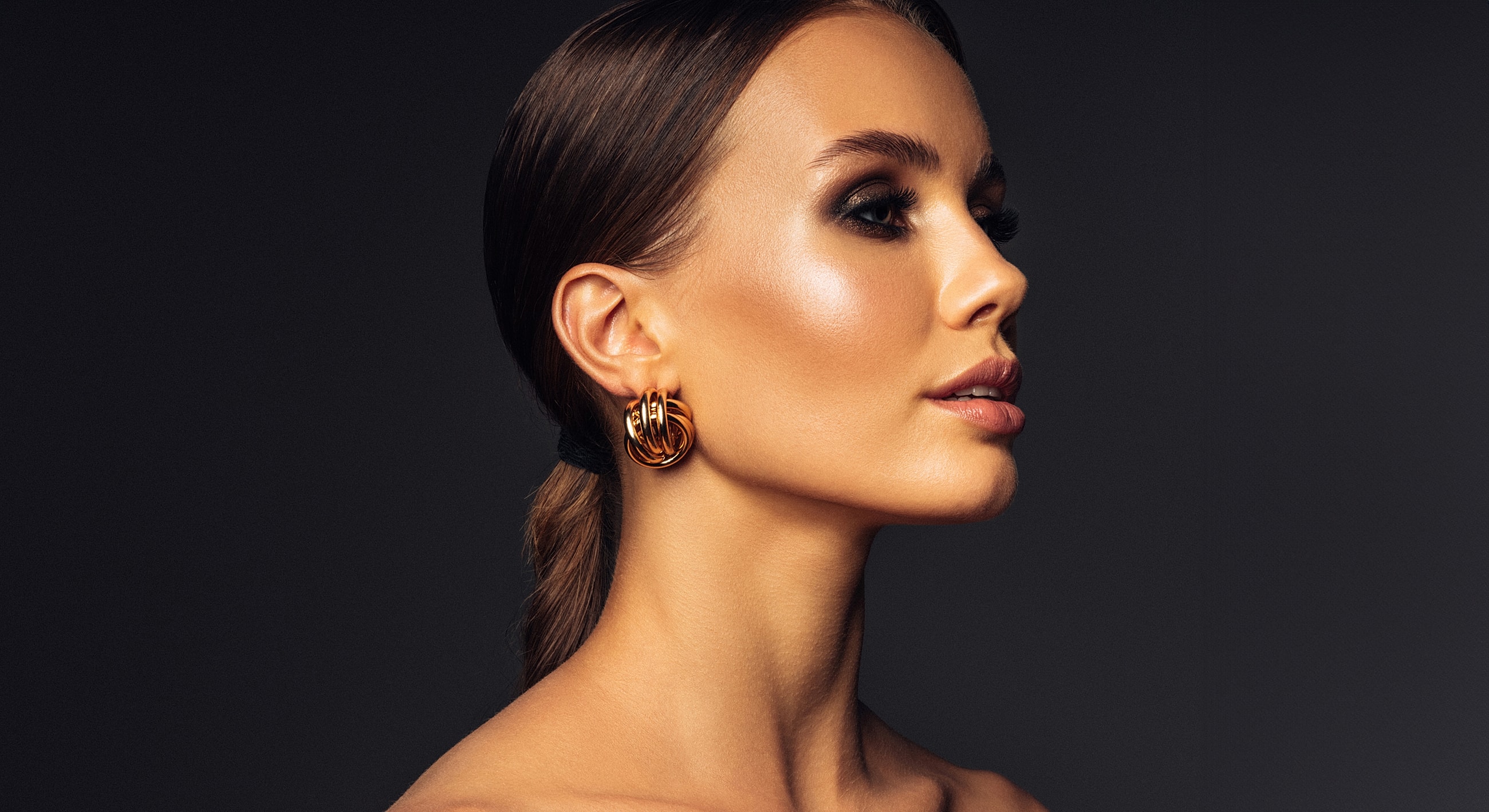 Profile of a woman with elegant earrings.