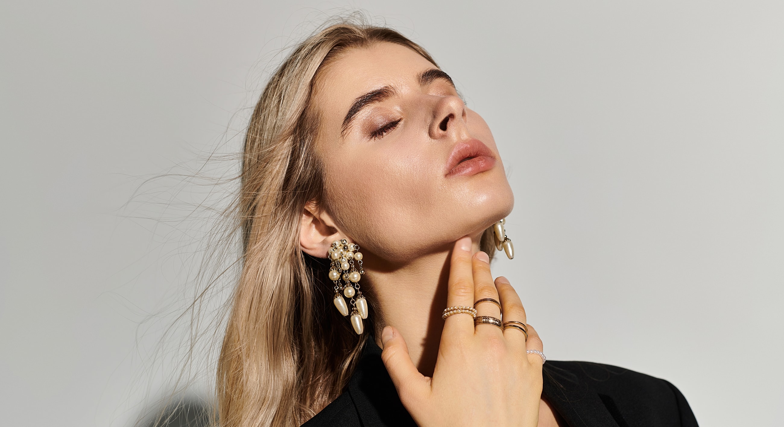 Woman showcasing elegant jewelry and accessories.