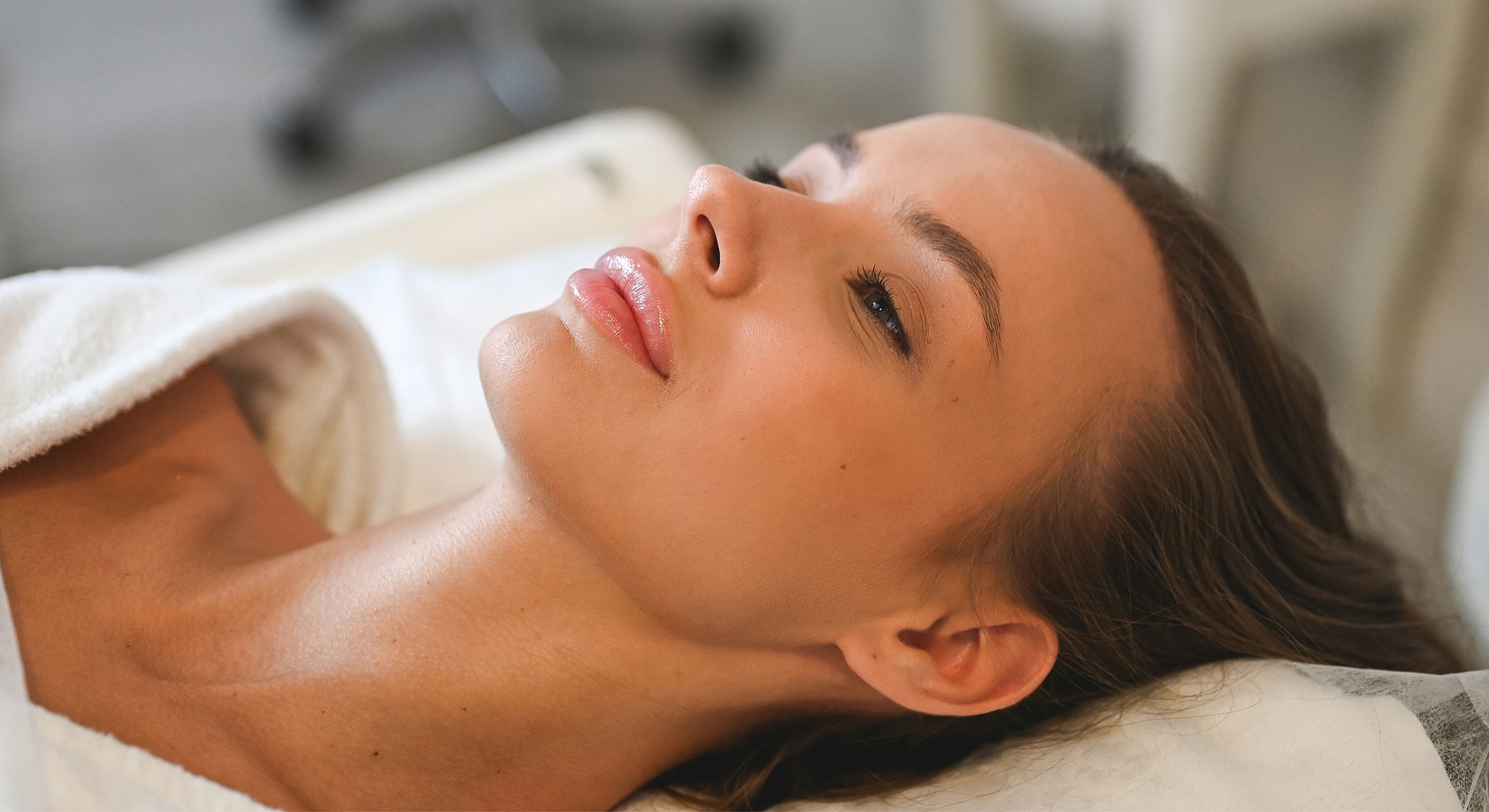 Woman relaxing during a facial treatment.